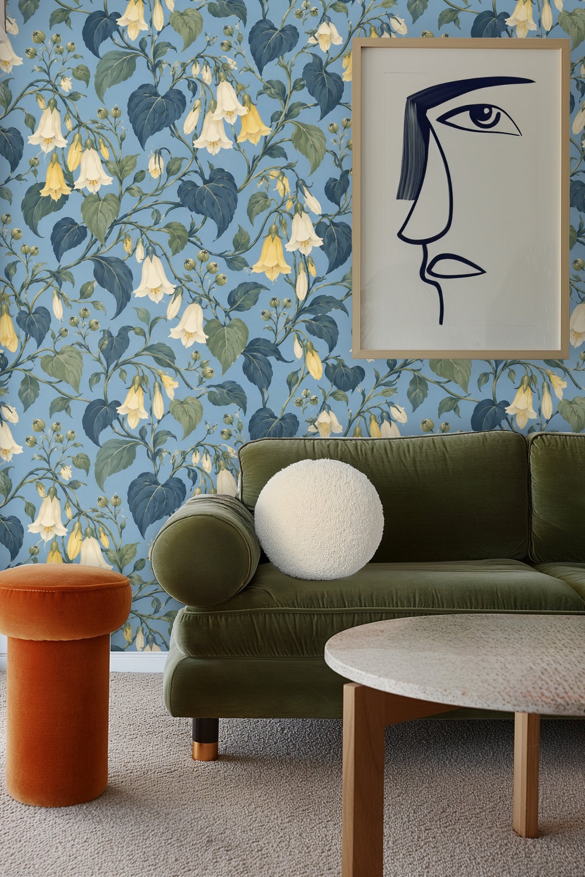 Living room wall covered in botanical wallpaper with hanging chair and neutral cushions