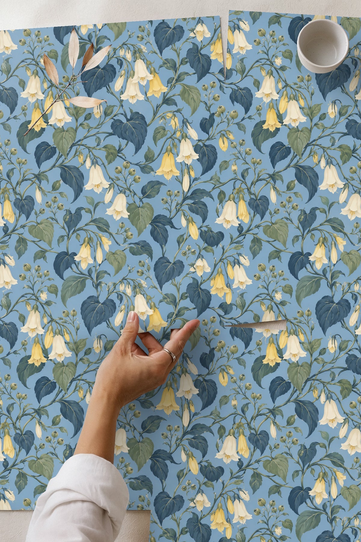Room scene with botanical wallpaper and natural light highlighting pattern scale