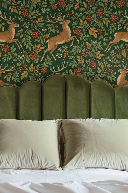 Wallpaper pattern showing four leaping stags intertwined with clusters of red rowan berries and golden leaves on a dark green background.