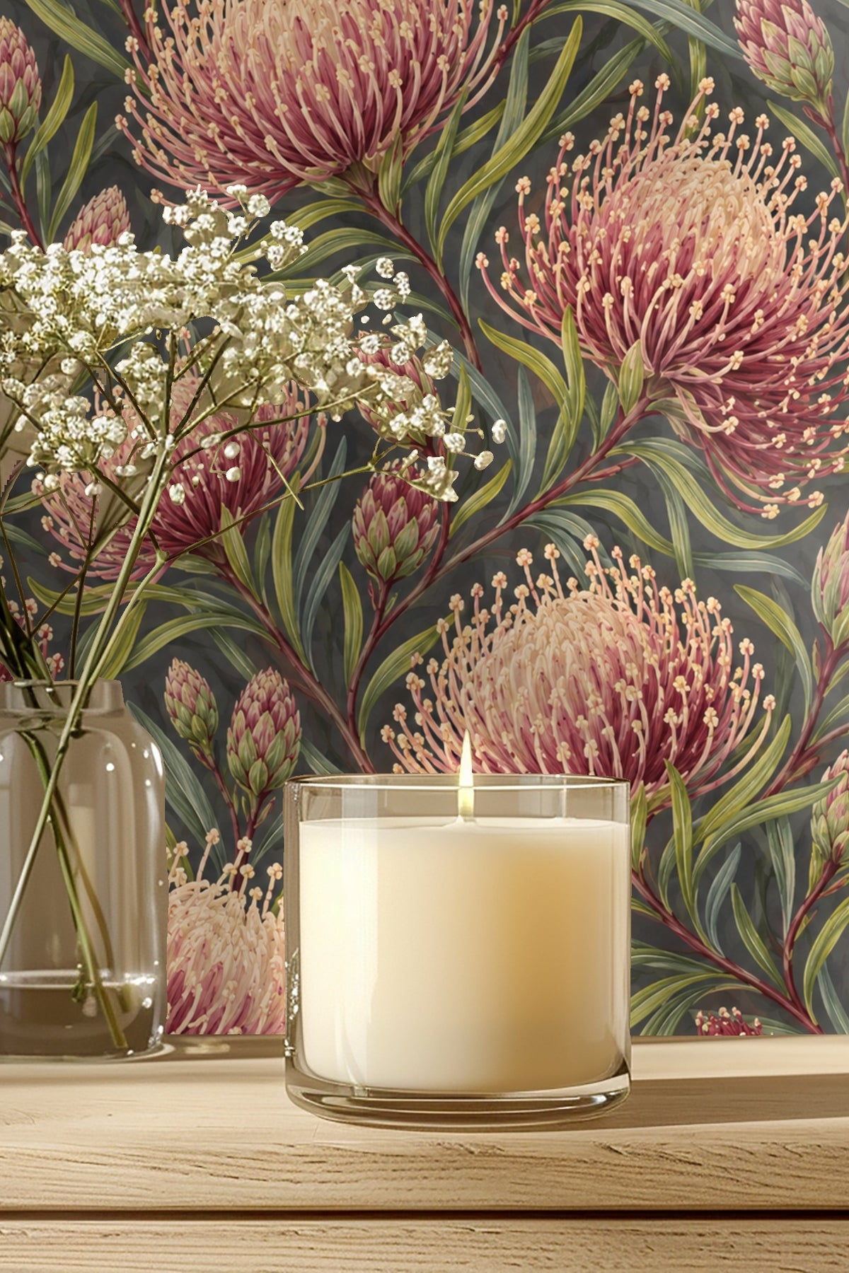 Detailed view of crimson and blush pincushion protea flowers with green leaves on charcoal background wallpaper.