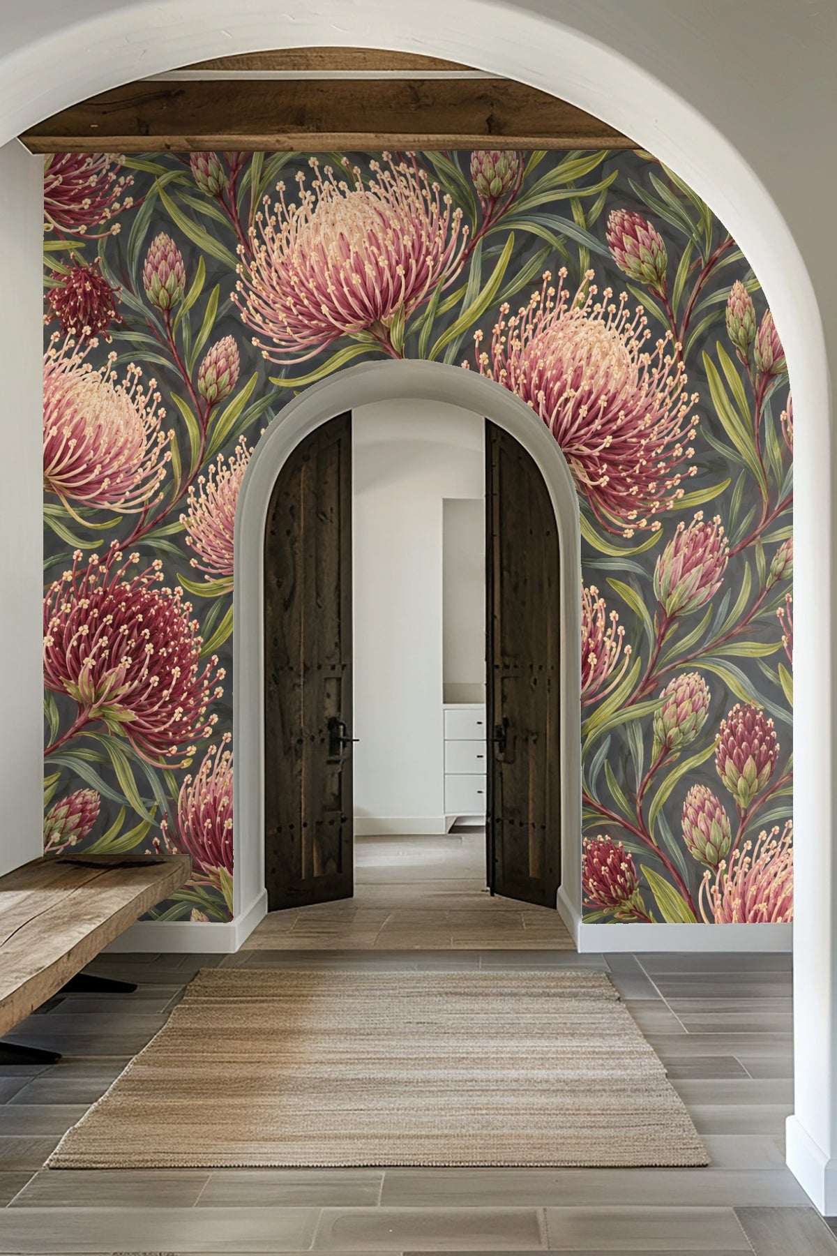 Laundry room with washing machines under a window, featuring pincushion protea floral wallpaper.