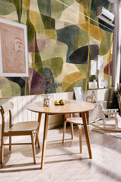 Neutral living room wall covered in artful olive and gold abstract wallpaper.