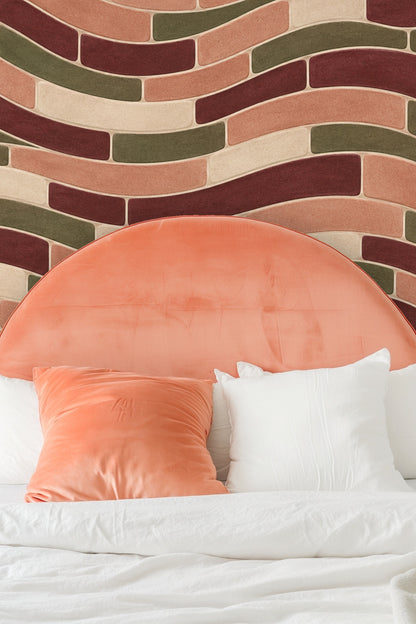 Wall detail showing textured curved tile shapes in terra cotta and earth tones.