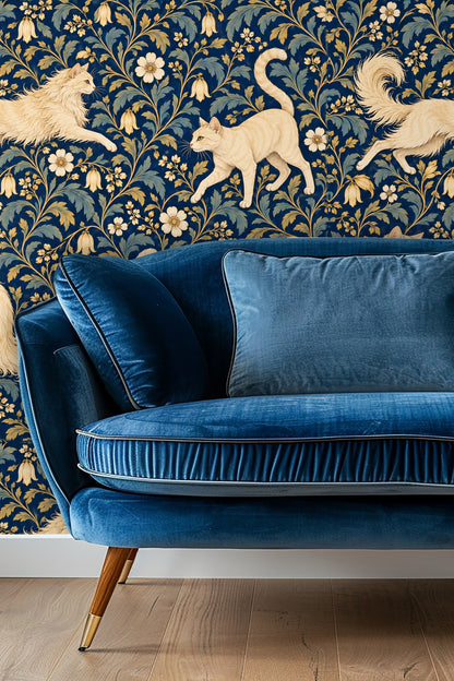 Living room scene with velvet blue sofa against cat and floral wallpaper