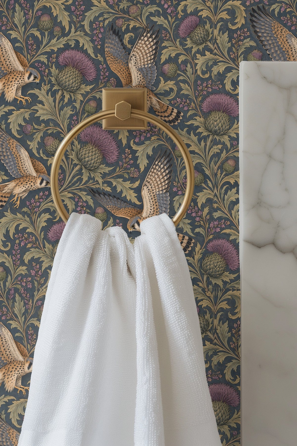 Close-up of blue velvet sofa against wallpaper with kestrels and thistles