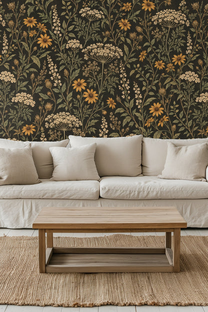 Partial view of floral pattern with yellow daisies and small white flowers on black wallpaper