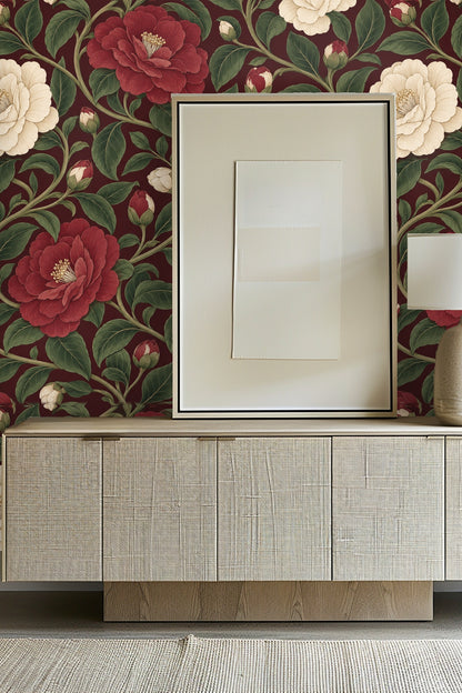 Close-up of wallpaper floral pattern showing detail of deep red camellia flower and green leaves.