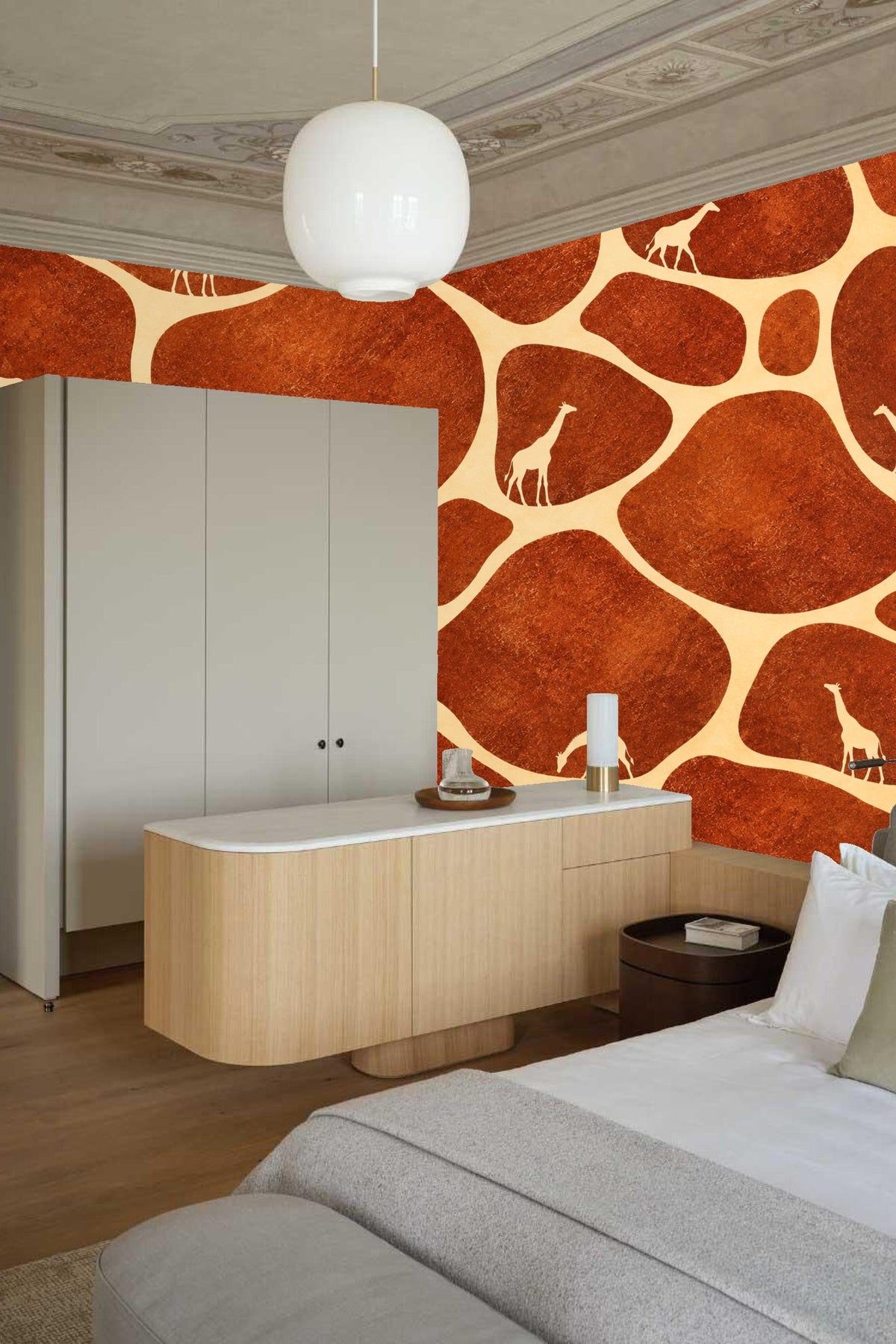 Room with white sofa featuring terracotta and cream giraffe wallpaper accent wall