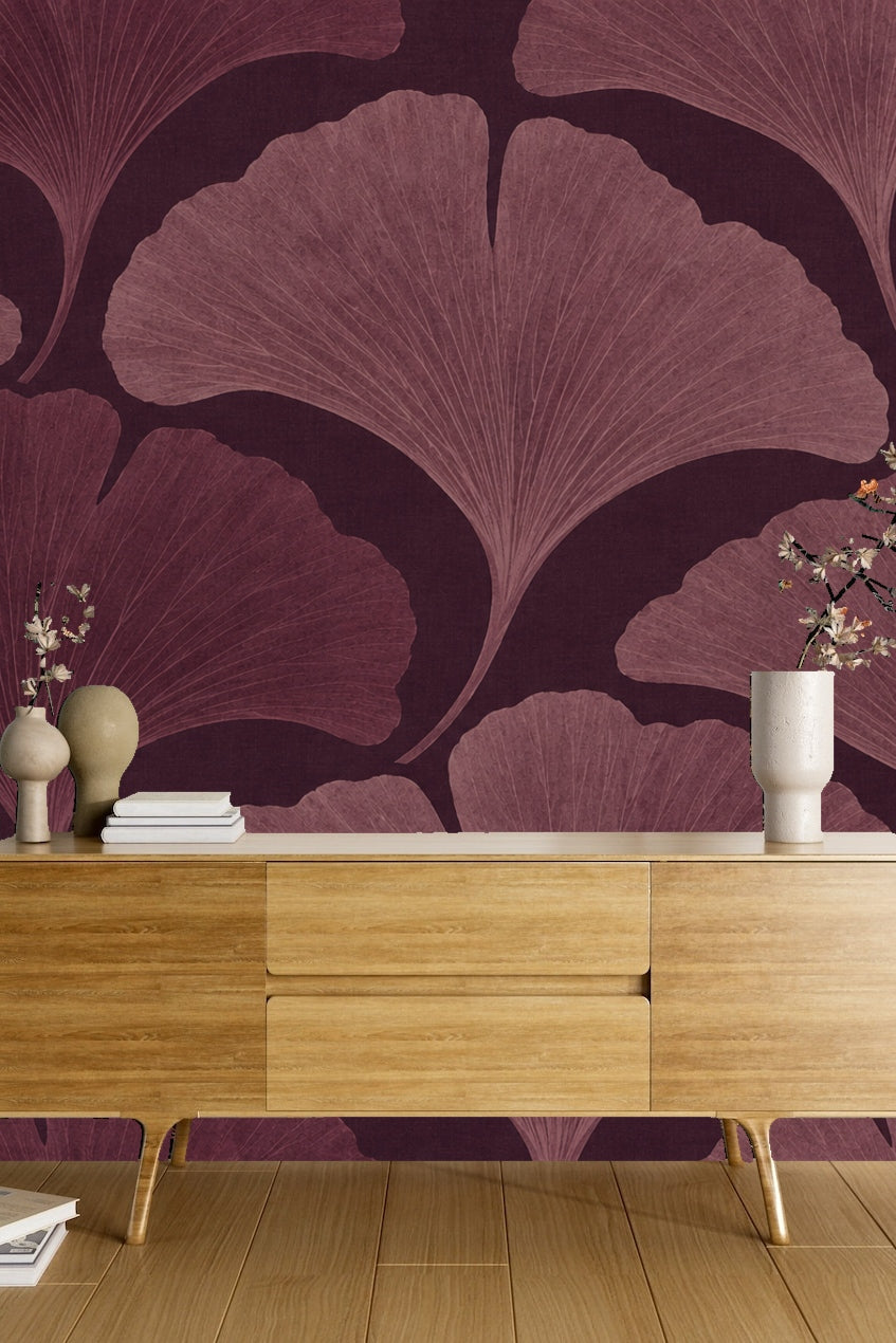 Stylized botanical wallpaper in a muted plum palette under soft lighting