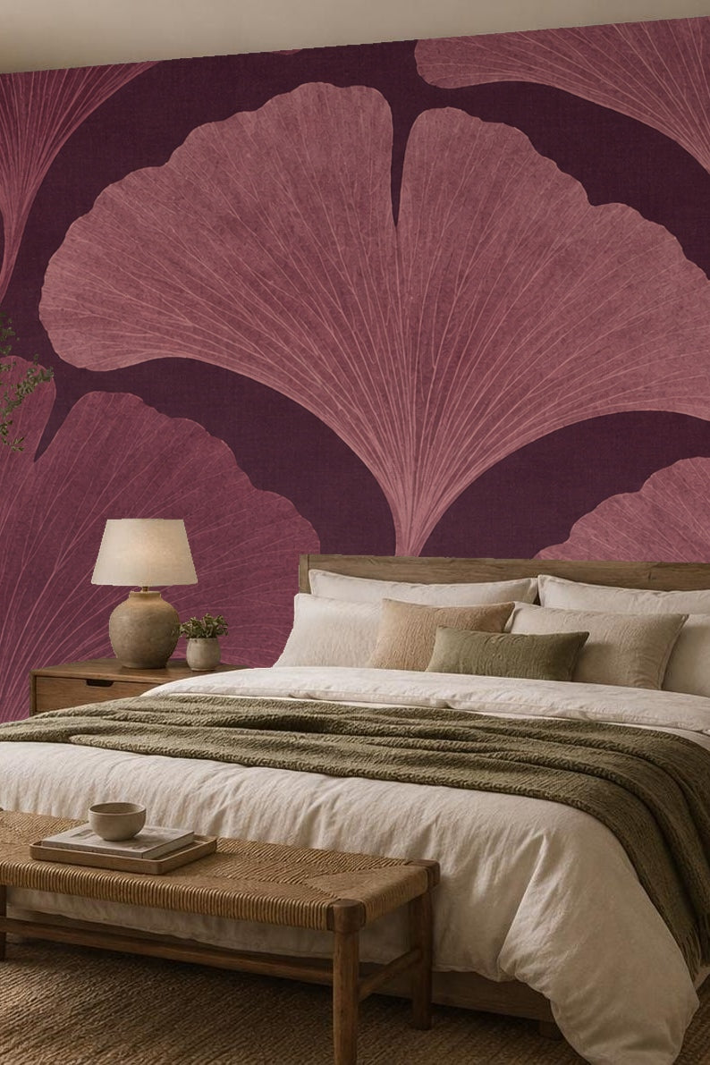Child's room corner featuring oversized plum ginkgo leaf wallpaper with a woven basket and star toy