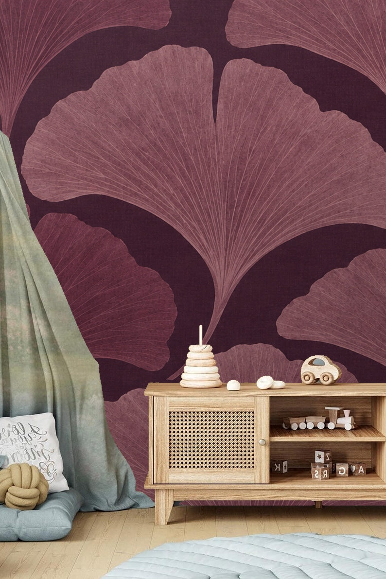 Entryway bench against wall with large-scale plum ginkgo leaf wallpaper and black-and-white photo frame