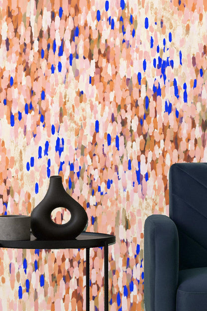 Bedroom corner featuring wallpaper with coral and cobalt petal motif behind wooden bed