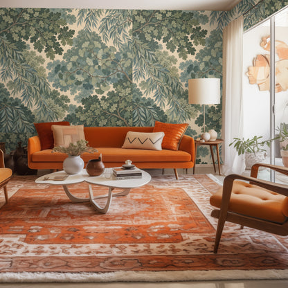 Living room feature wall with the botanical wallpaper behind an orange mid-century sofa and rug