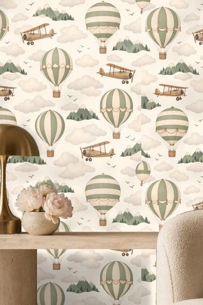 Detail of hot air balloon basket and striped balloon in muted green and cream tone on black background.