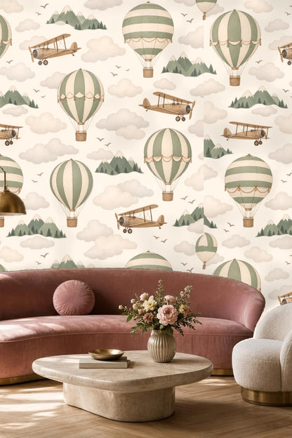 Light living room wall covered with vintage hot air balloons wallpaper in soft sage and cream tones behind beige pillows.