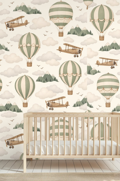 Close-up of vintage hot air balloons and biplanes in muted sage green and sepia against black sky with clouds and mountains.