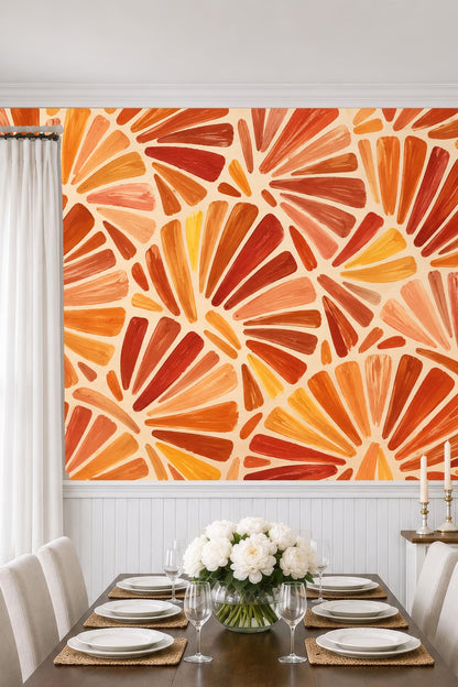 Modern armchair and wooden crib sit before expressive terracotta fan patterned wallpaper
