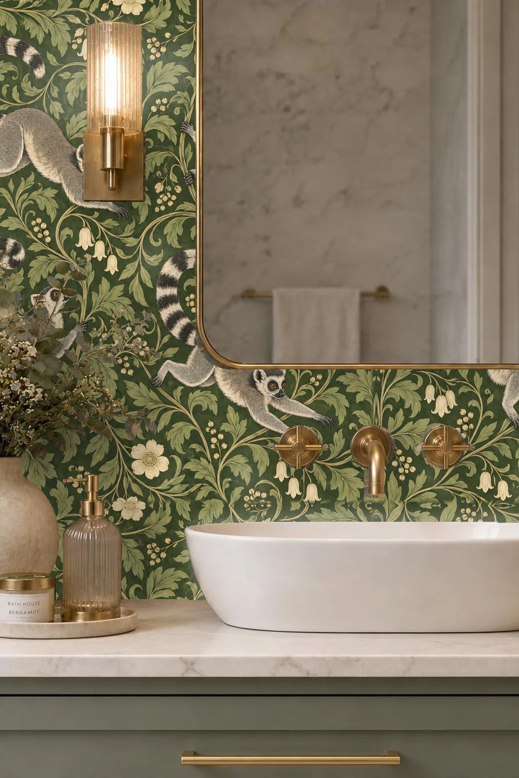 Bedroom headboard with green velvet upholstered scalloped top against wallpaper featuring lemurs and botanical scroll design