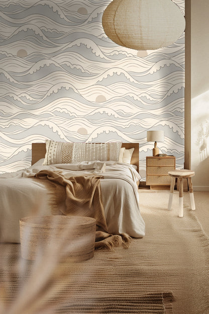 Living room wall covered in Quiet Crest Waves wallpaper behind a light beige couch with white pillows