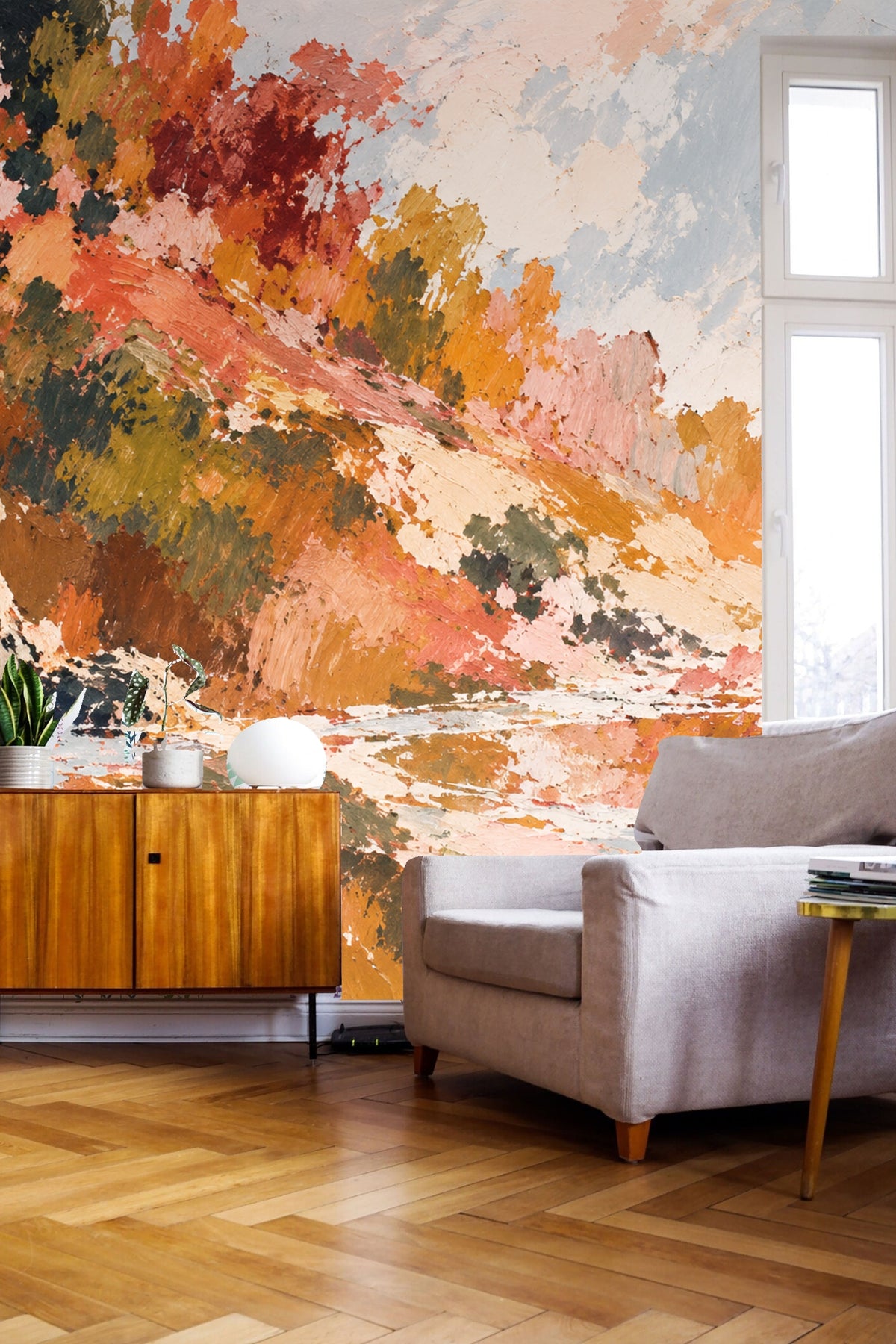 Wallpaper behind a white sofa with nesting tables and natural decor