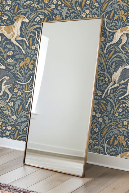 View of a corner wall in room fully covered with blue and gold botanical wallpaper featuring running dogs