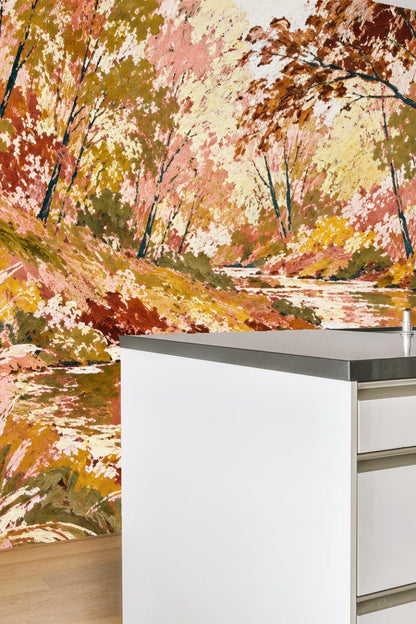 Close-up detail of brushstroke texture showing pink and ochre leaves against dark tree trunks