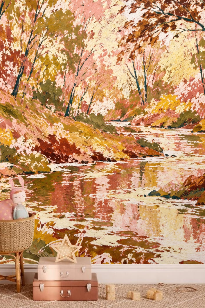 Painterly wallpaper artwork depicting an autumn stream bordered by trees in pink, gold, and rust hues.