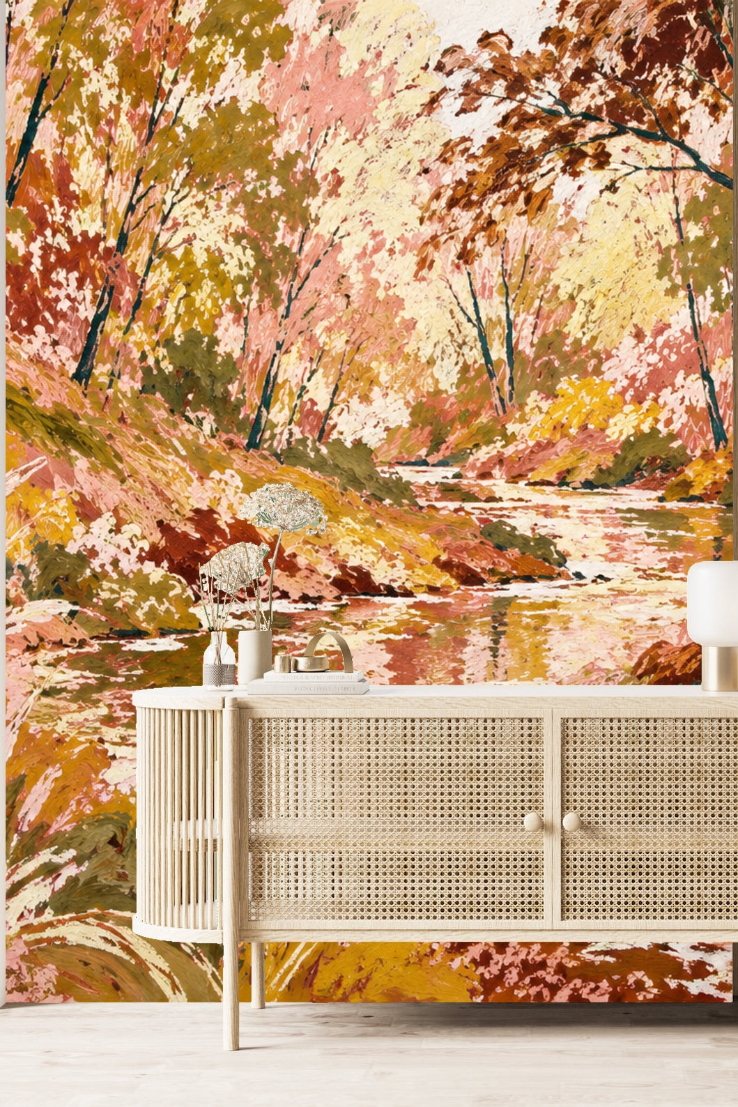 Waterway leading into dense woods with a warm palette of pinks, ochres, and soft whites
