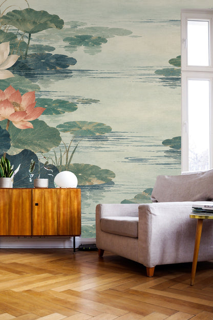 Living room corner with lotus pond wallpaper behind yellow chair and houseplant on pale wood floor.
