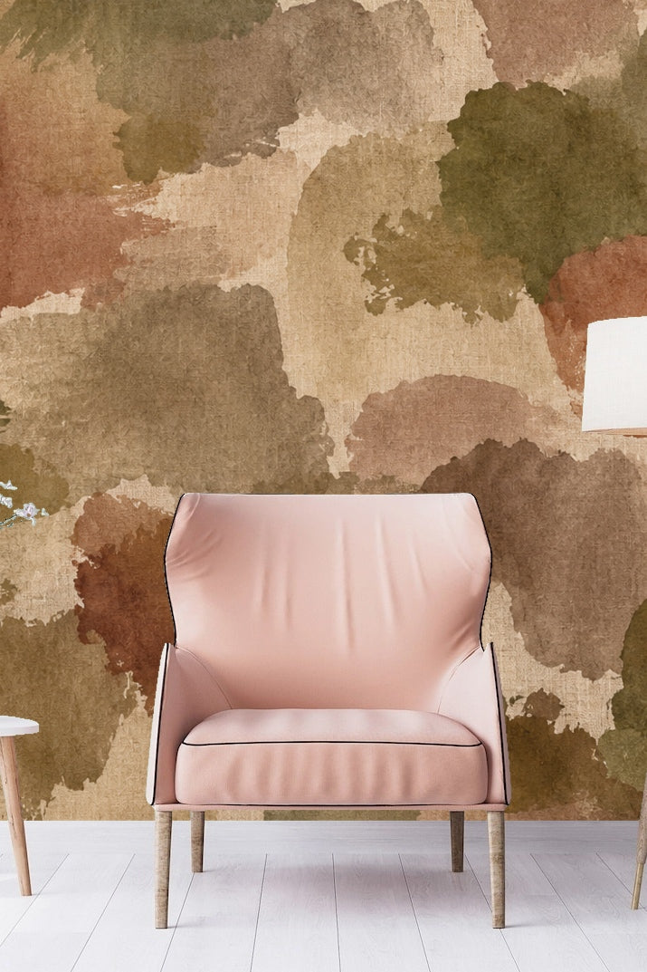 Living room with blush chair and watercolor earth tone wallpaper