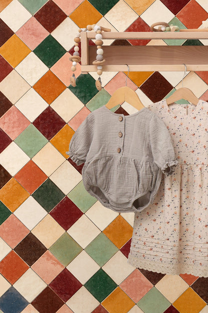 Textured tile surfaces in terracotta grid wallpaper