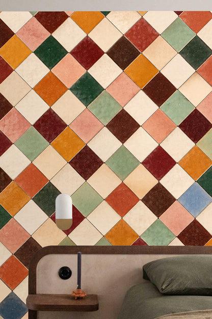 Room interior with terracotta tile grid wallpaper behind wooden sideboard and round mirror