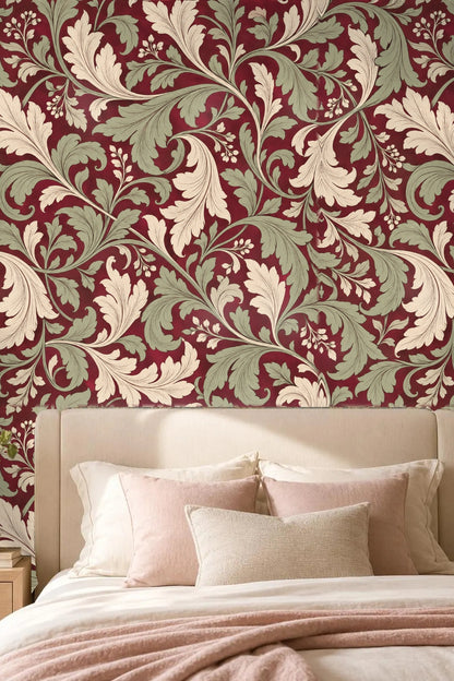Detail of large flowing acanthus leaf motif in cream and sage on deep crimson background
