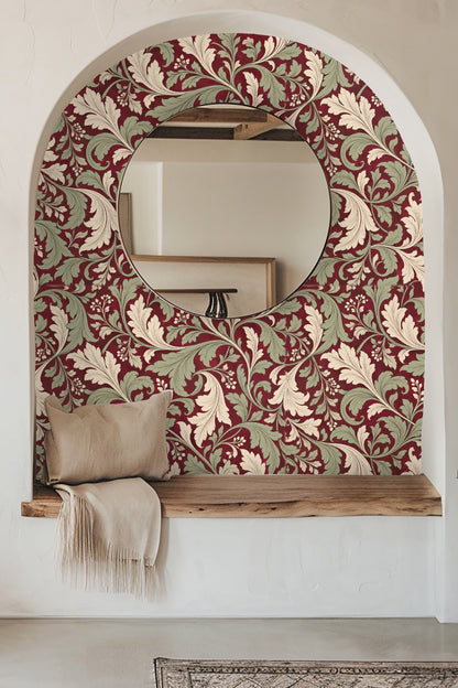 Room with orange sofa and large wall covered in crimson wallpaper with cream and sage acanthus leaf pattern