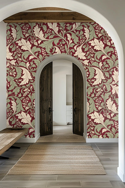 Wall mural with sweeping leaf motifs in pale cream and soft green over dark crimson
