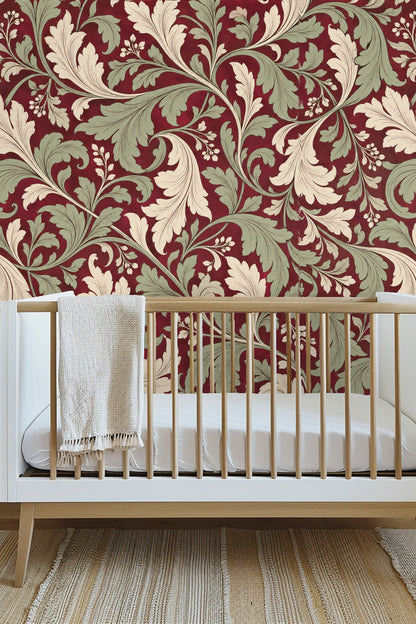 Close-up on swirling acanthus leaves in muted green and ivory on rich red wallpaper
