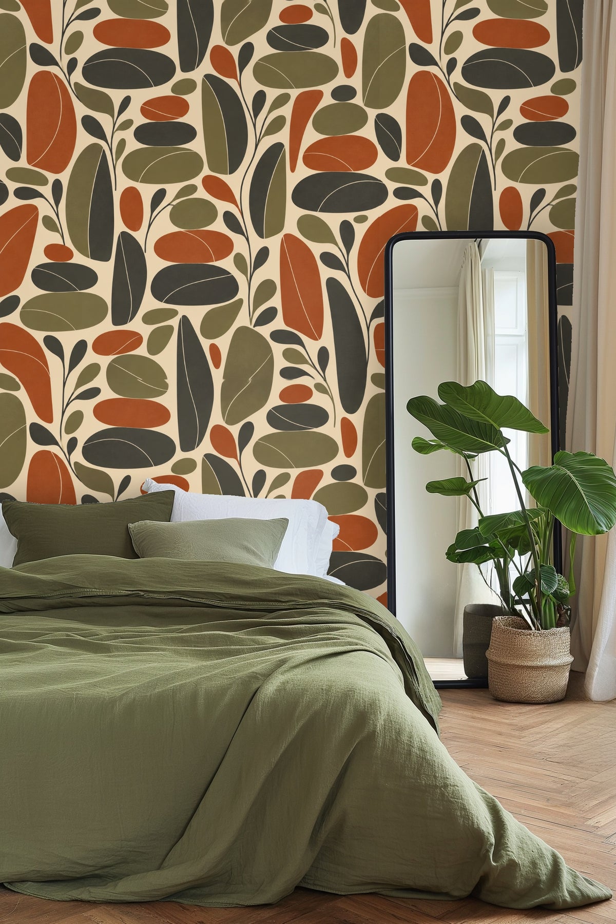 Retro leaf wallpaper as backdrop in a living room with soft cream sofa and velvet cushions.