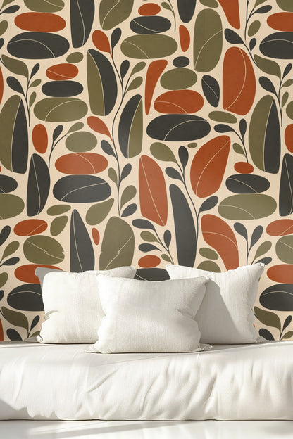 Living room corner with retro leaf wallpaper and green velvet stool.