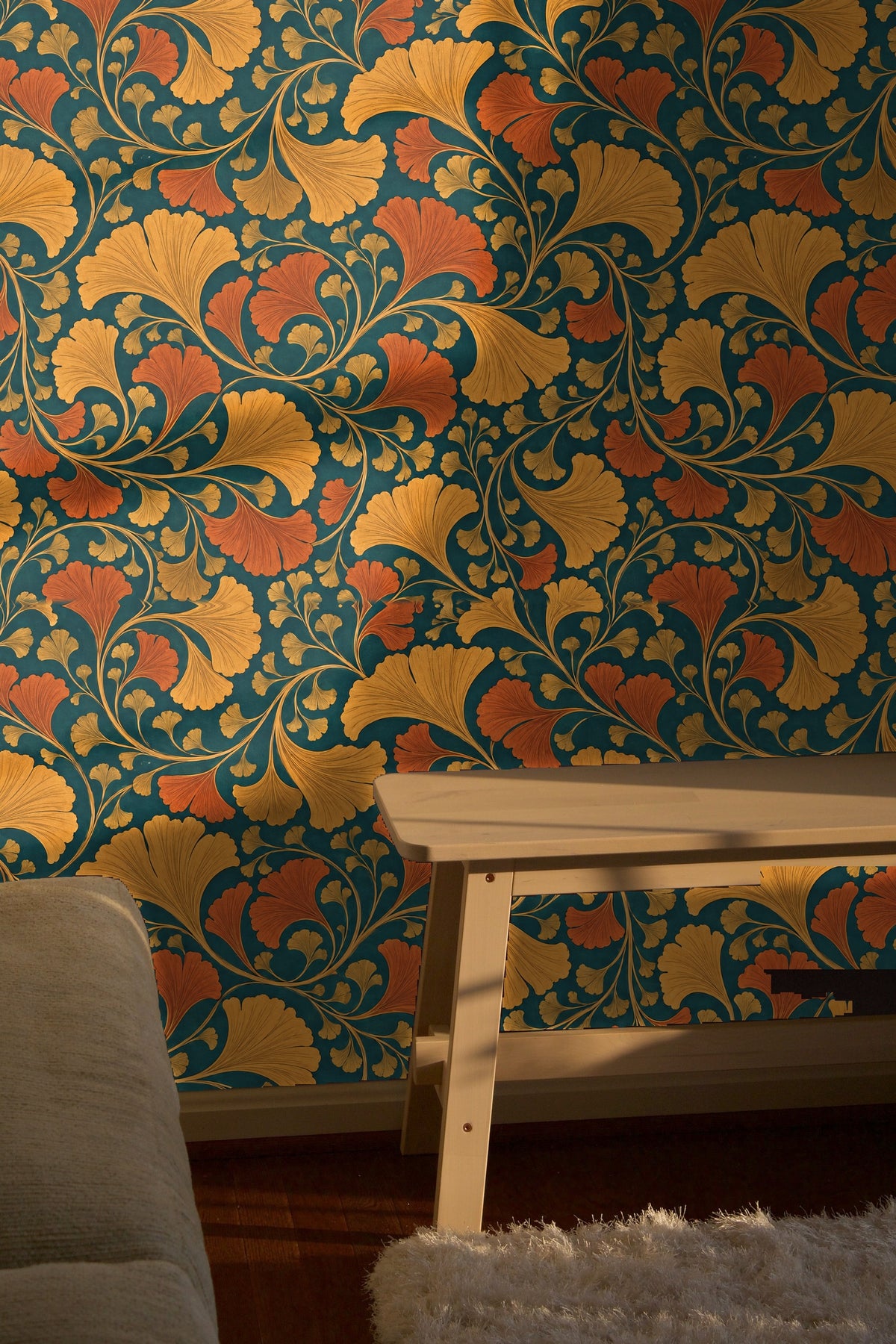 Laundry room with amber rust teal wallpaper behind white washer and dryer