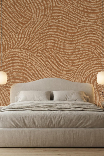 Room corner showing continuous curved line pattern wallpaper in natural terracotta.