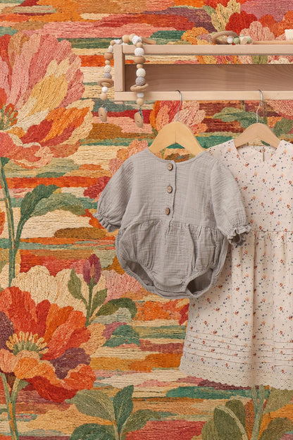 Flower buds and leaves accentuated in embroidered-style wallpaper artwork
