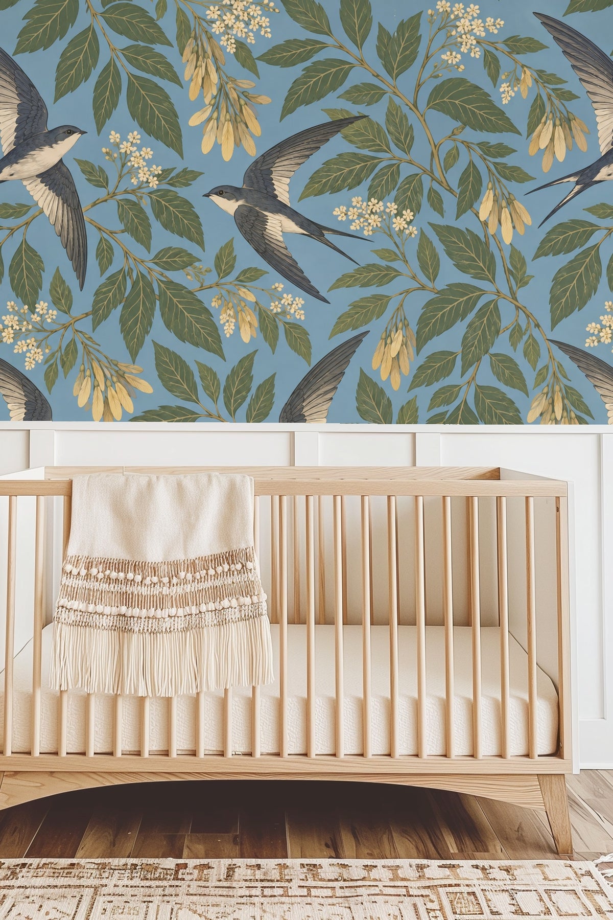 Bedroom wall wallpaper with swallows and laurel foliage behind a natural wood headboard and white bedding with cream pillow