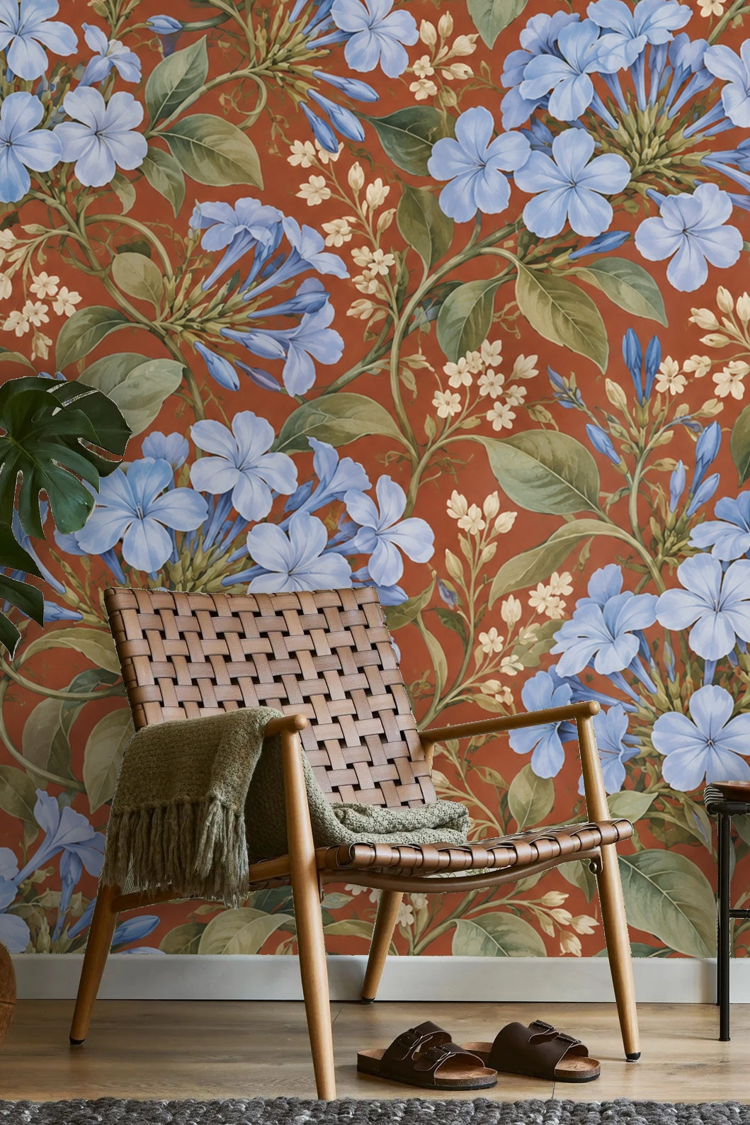 Wallpaper application in progress with painterly blue florals and earthy background