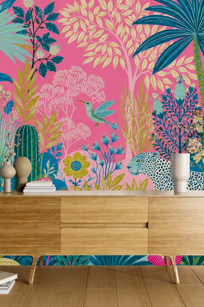 Children's room decorated with vivid pink tropical wallpaper showing leopard and exotic plants, styled with playful furnishings