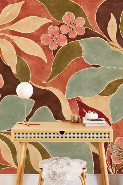 Section of wallpaper illustrating large sculptural leaves in muted green and cream hues intertwined with soft pink flowers.