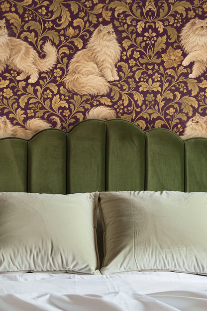 Entryway alcove wall covered with wallpaper showing creamy Persian cats sitting and walking amid golden leaves on a plum base.