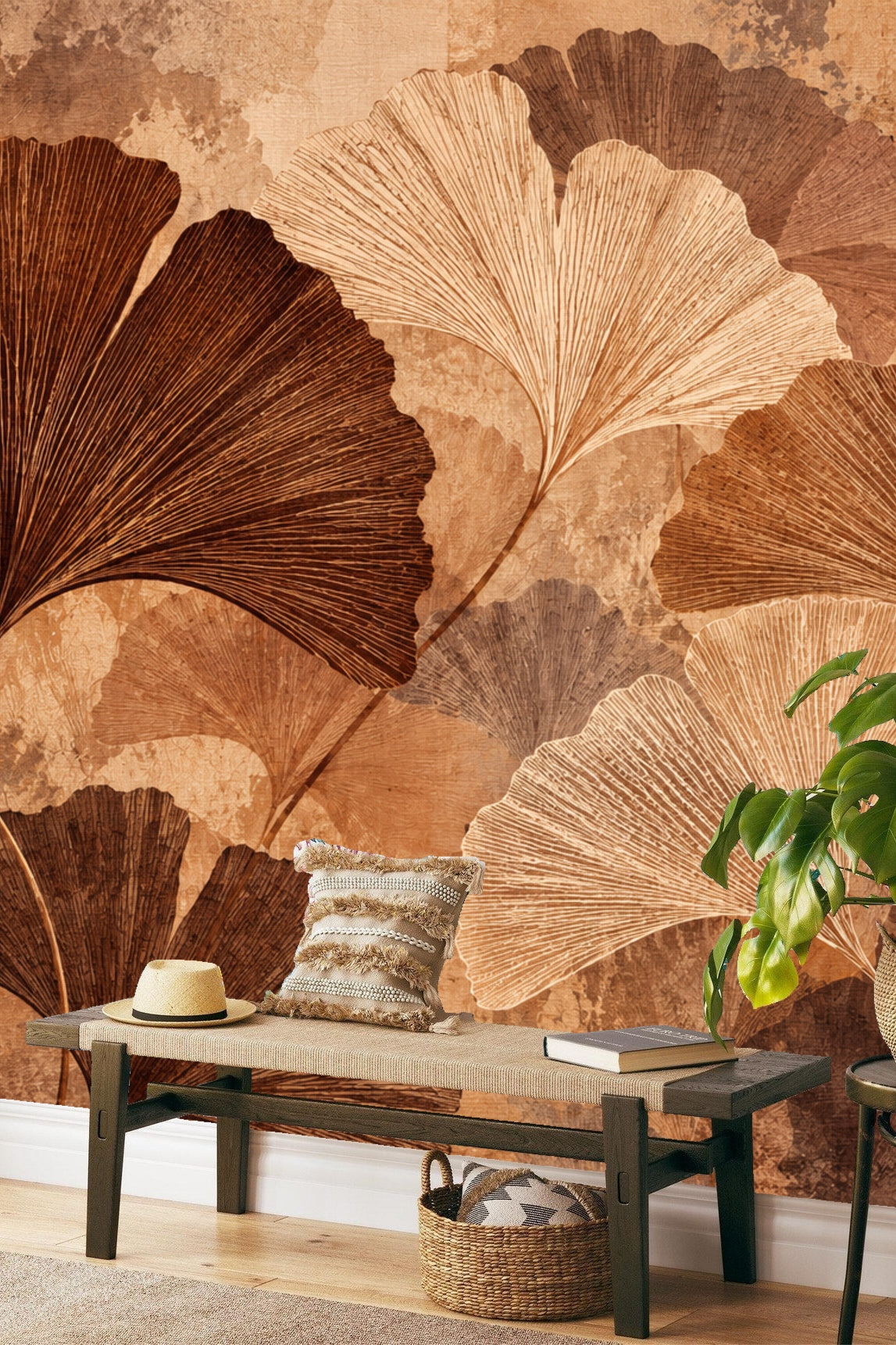 Bedroom wall with Ochre Ginkgo Canopy wallpaper behind white bedding and a small white wall light