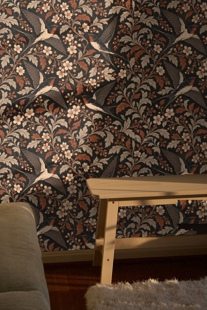 Botanical pattern showing stylized cream flowers and curved leaves with flying birds