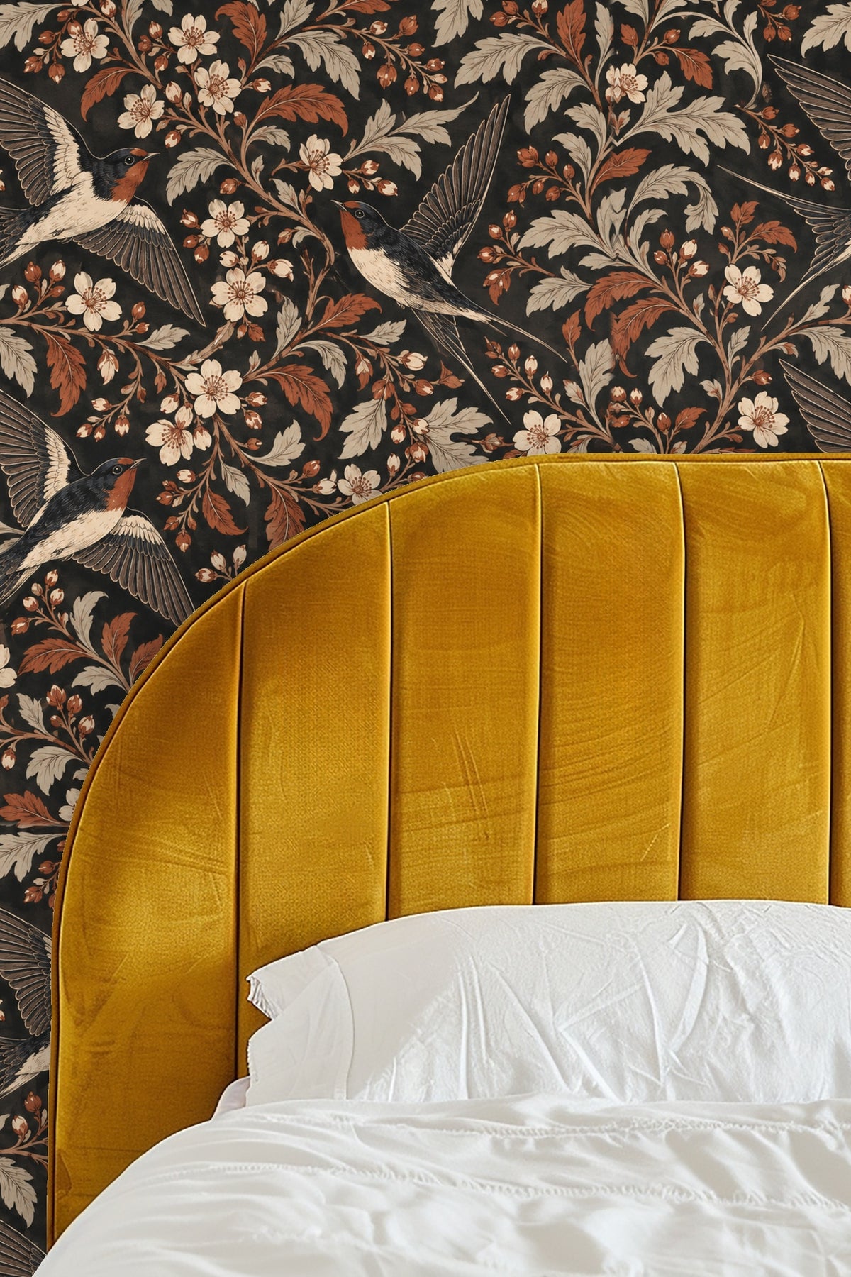 Living room with plush pink curved sofa and wallpaper featuring swallows and cream and burnt sienna leaves