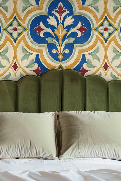 Close-up view of a large-scale blue, gold, red, and green floral trellis wallpaper pattern
